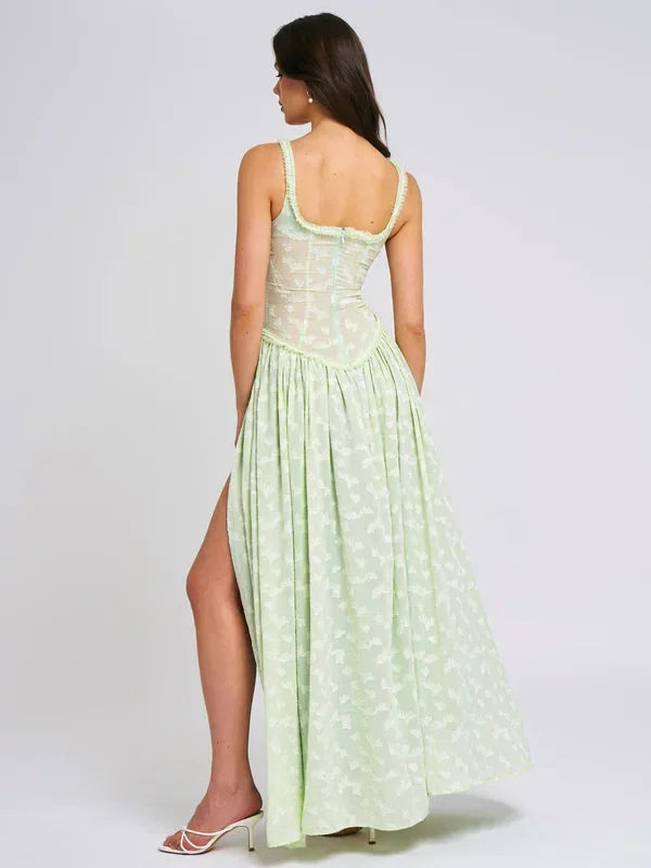 Robe longue verte à fleurs avec fente et corset, en tissu léger, idéale pour des soirées d'été élégantes.