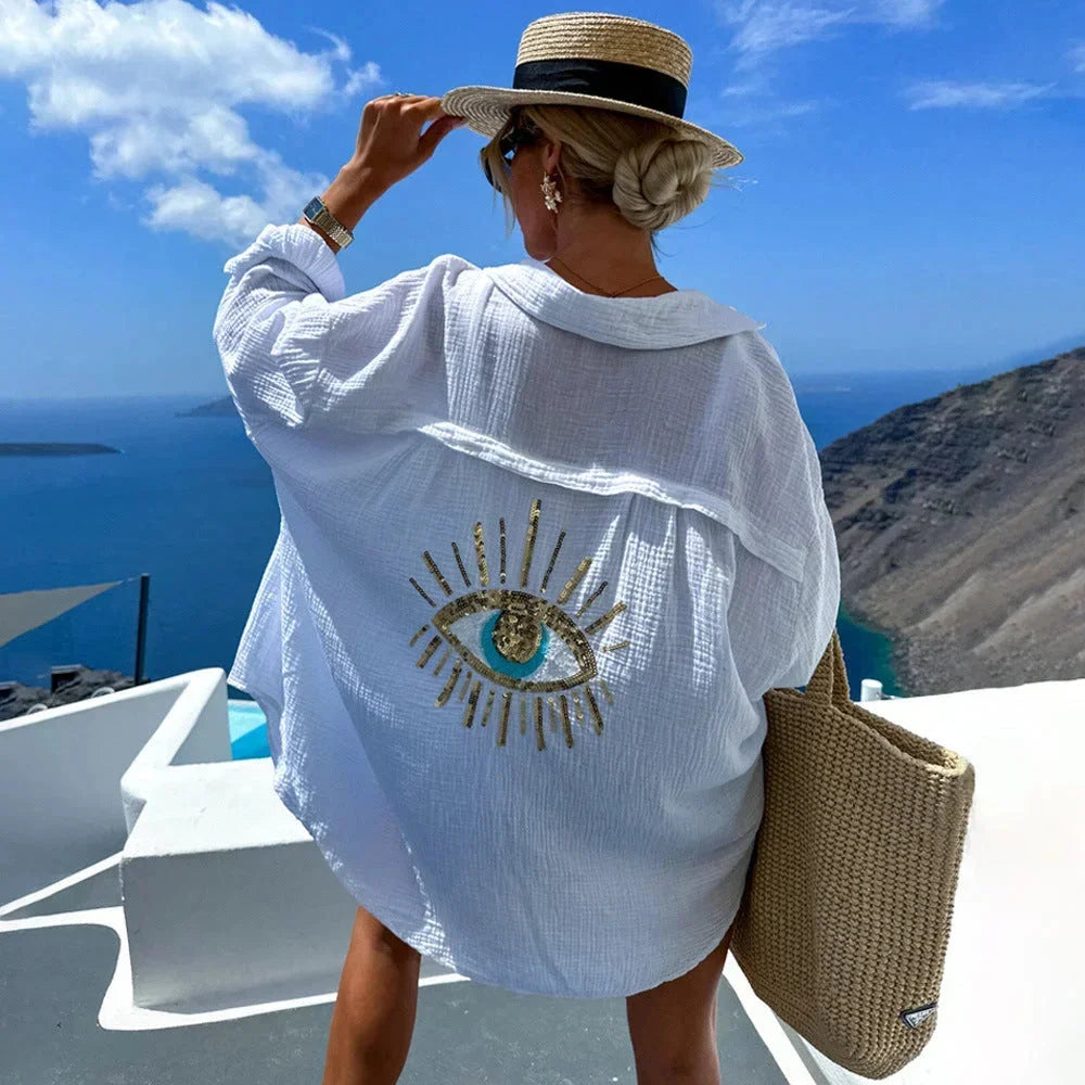 Blouse femme oversize en coton, avec motif œil brodé sur le devant, manches longues et coupe décontractée.