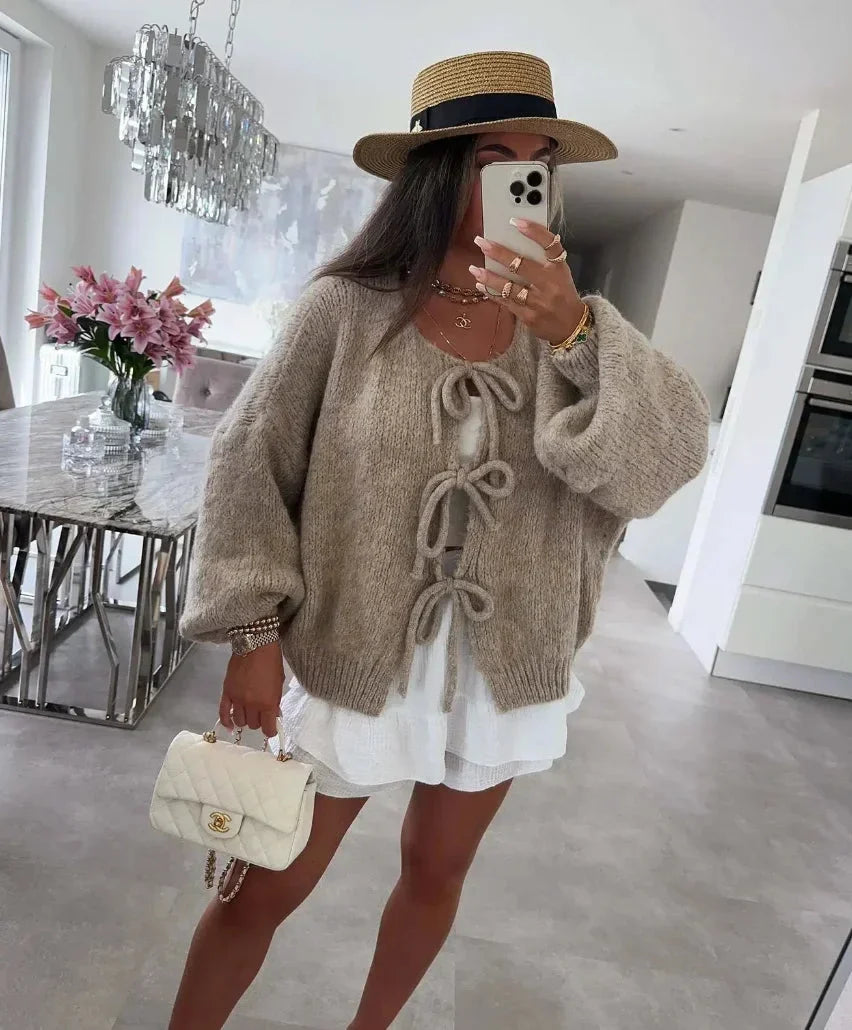 Cardigan femme gris avec manches amples tricotées et design noué, adapté pour des tenues décontractées.