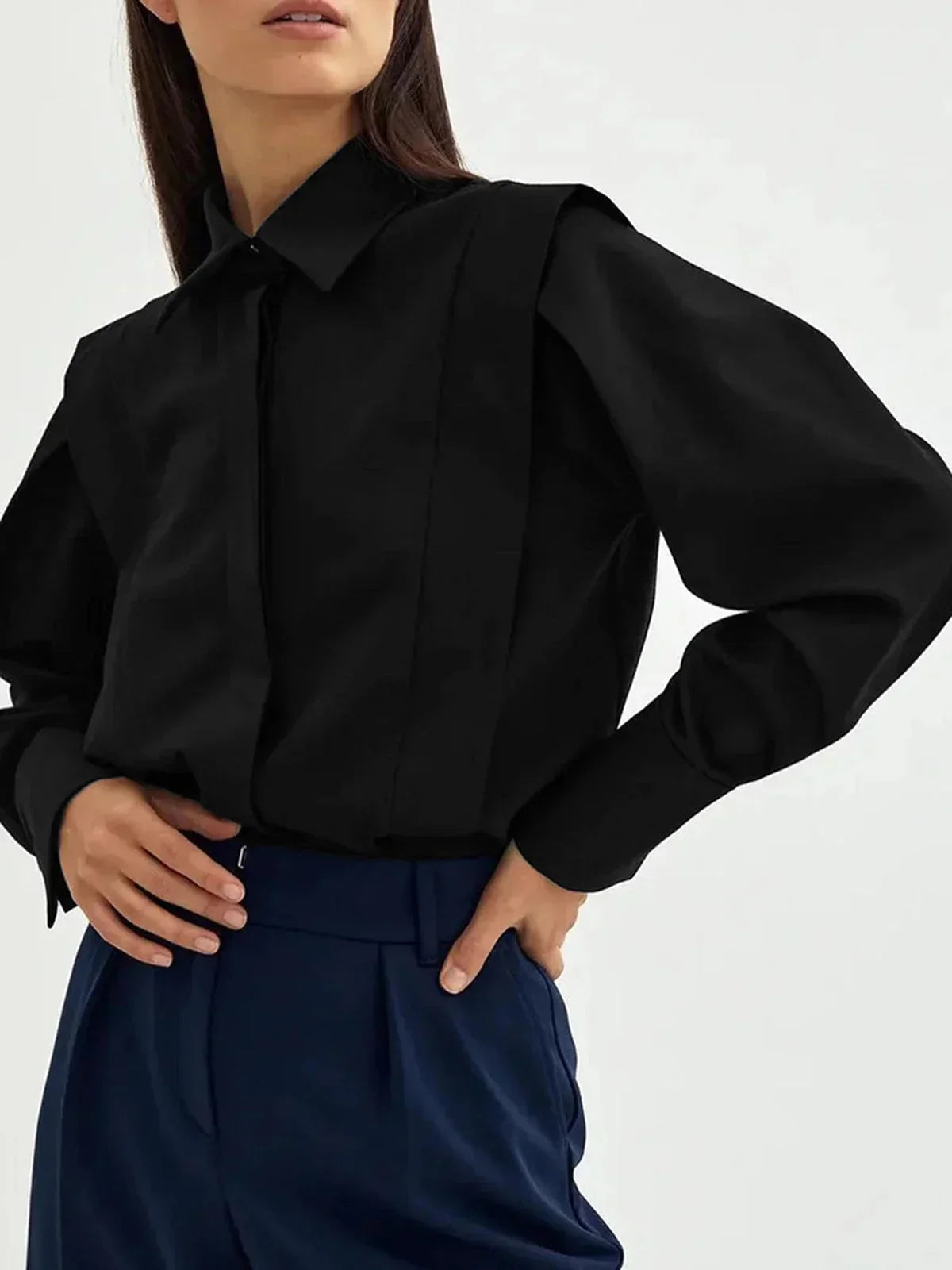 Chemisier oversize femme noir en coton, avec détails boutonnés sur le devant et manches longues. Parfait pour une tenue…