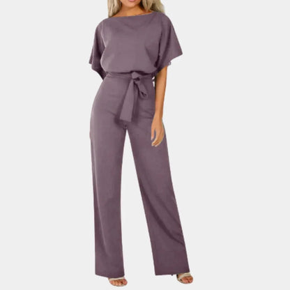 Combinaison femme abricot à jambes larges, ceinture et manches kimono en tissu léger.
