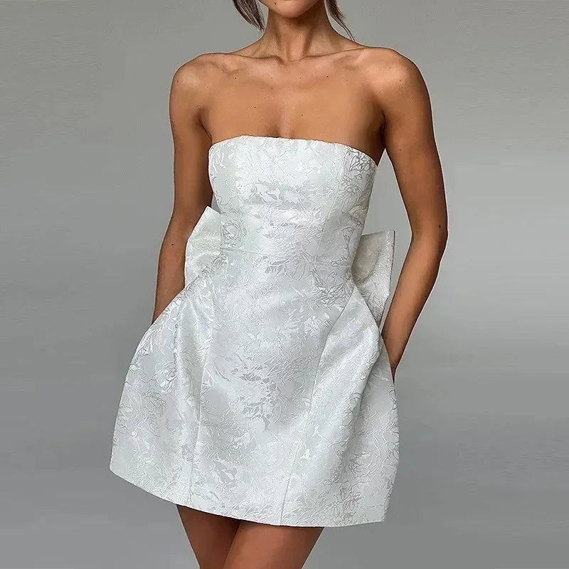 Robe courte femme en coton, bustier à dos lacé et nœud, idéale pour les sorties estivales, coloris pastel.