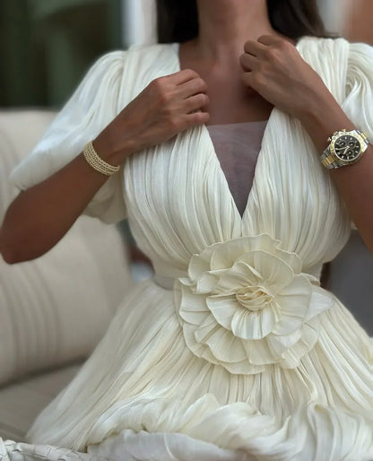 Robe de soirée blanche plissée en polyester, avec bretelles spaghetti et jupe fluide pour un look élégant.