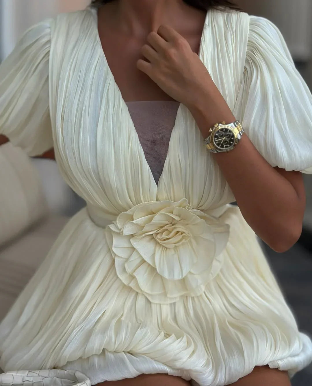 Robe de soirée blanche pour femme, en tissu plissé, avec une coupe élégante et des détails raffinés.