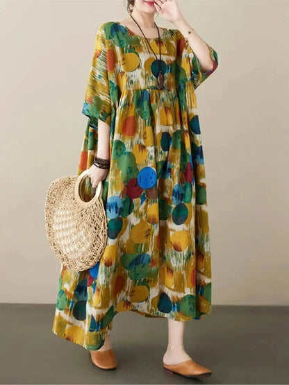 Robe longue verte en tissu fluide, ample, avec un imprimé artistique et des manches mi-longues. Idéale pour un look…