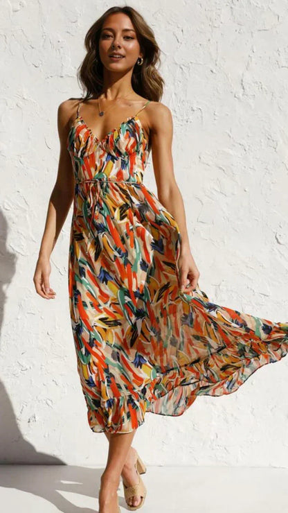Robe longue femme orange à bretelles fines avec imprimé végétal, en tissu léger et fluide, idéale pour les journées…