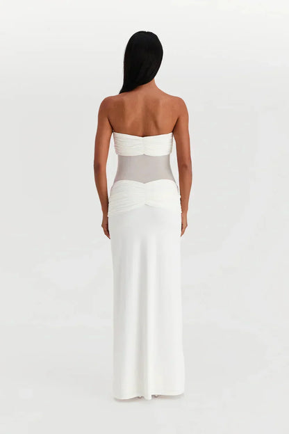 Robe longue femme en tissu fluide, bustier ajusté avec détail transparent et nœud à la taille pour un look élégant.