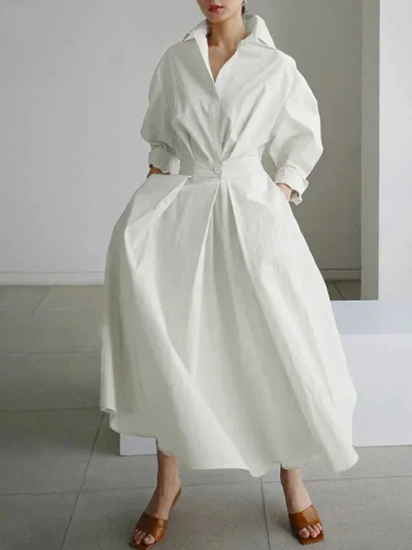 Robe longue femme en tissu léger, col fluide, manches longues et poches pratiques pour un style décontracté.