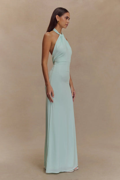 Robe longue dos nu en tissu léger couleur menthe douce, parfaite pour des occasions estivales et confortables.