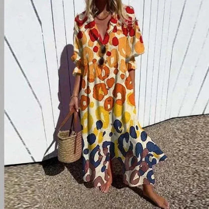 Robe longue jaune avec imprimé floral, col V, manches mi-longues, en tissu léger et fluide pour un confort estival.