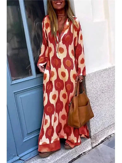 Robe longue femme rouge à manches longues, col V, en tissu fluide avec un imprimé coloré et un tombé élégant.