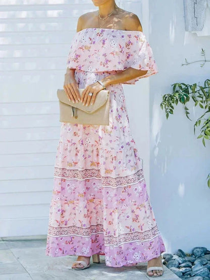 Robe longue femme à épaules dénudées, en tissu léger, avec motifs floraux colorés et taille ajustée.