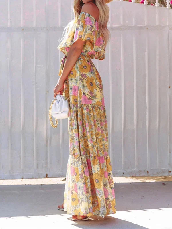 Robe longue pour femme, épaules dénudées, en tissu léger avec motifs floraux colorés, parfaite pour les journées d'été.