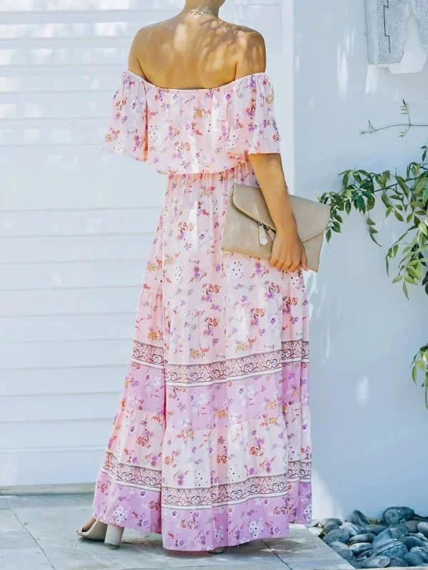 Robe longue femme, épaules dénudées, en tissu léger avec motifs floraux colorés, idéale pour les journées d'été.