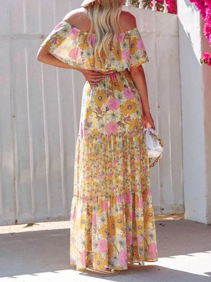 Robe longue femme avec épaules dénudées, en tissu léger, ornée de motifs floraux colorés pour un look estival.