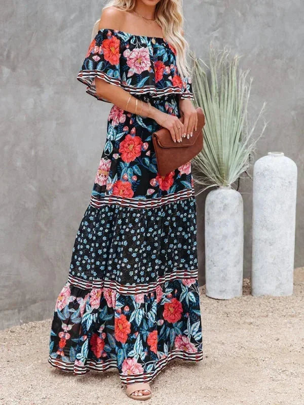 Robe longue femme épaules dénudées, en tissu léger, à motifs floraux sur fond bleu foncé, idéale pour l'été.