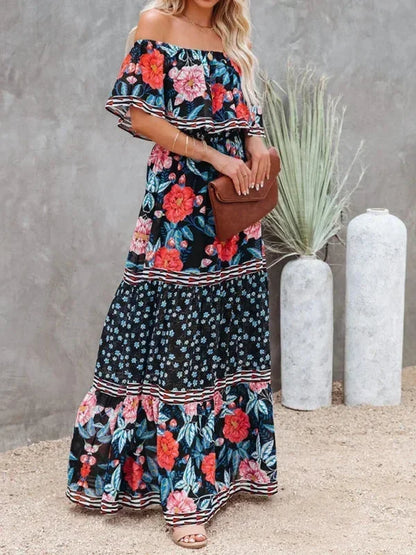 Robe longue femme épaules dénudées, en tissu léger, à motifs floraux sur fond bleu foncé, idéale pour l'été.