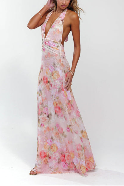 Robe longue femme rose fleurie, en tissu léger, design à dos nu avec motifs floraux et coupe fluide.