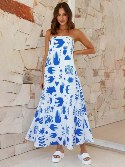 Robe longue sans bretelles pour femme, en tissu léger, ornée de motifs estivaux colorés idéale pour les journées chaudes.
