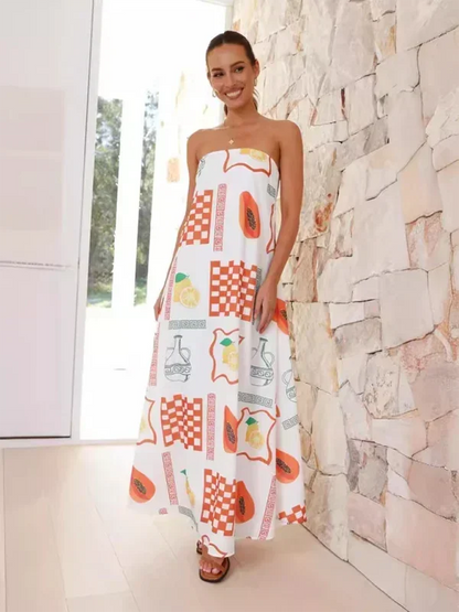 Robe longue sans bretelles en coton léger, ornée de motifs estivaux colorés et d'une coupe fluide pour un look décontracté.