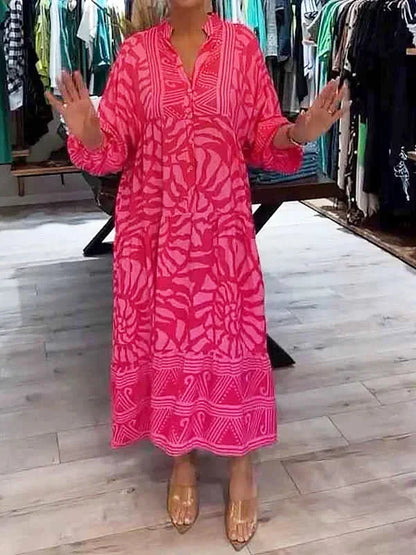 Robe longue fluide en rose, imprimée avec manches longues et col en V, en tissu léger et confortable pour un port agréable.