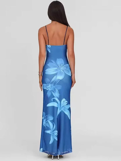 Robe maxi femme en tissu léger, imprimé floral coloré et bretelles fines, idéale pour les journées d'été.
