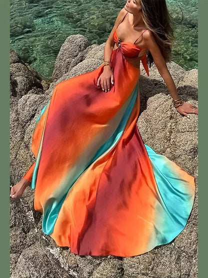 Robe maxi femme en jersey, dégradé orange et turquoise, avec découpes élégantes sur les côtés et un décolleté.