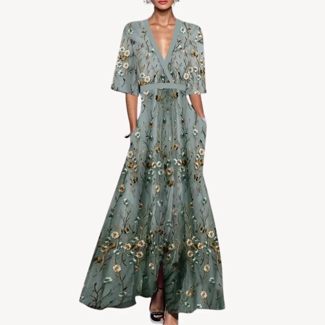 Robe longue fluide en viscose avec manches mi-longues, bordure contrastée et poches pratiques pour un confort quotidien.