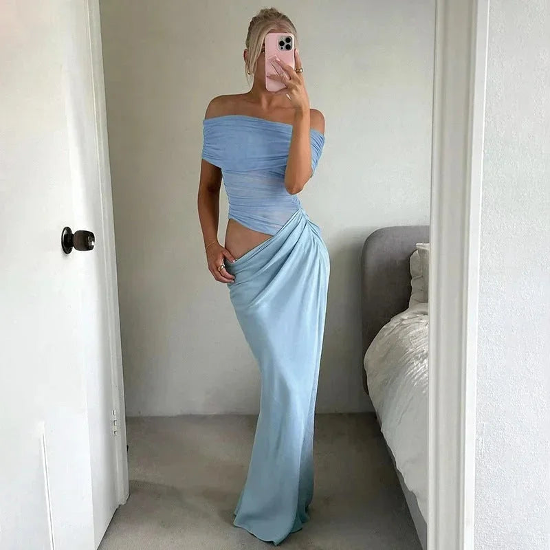 Robe longue en tissu fluide, épaules dénudées, taille froncée avec découpe, parfaite pour des occasions décontractées.