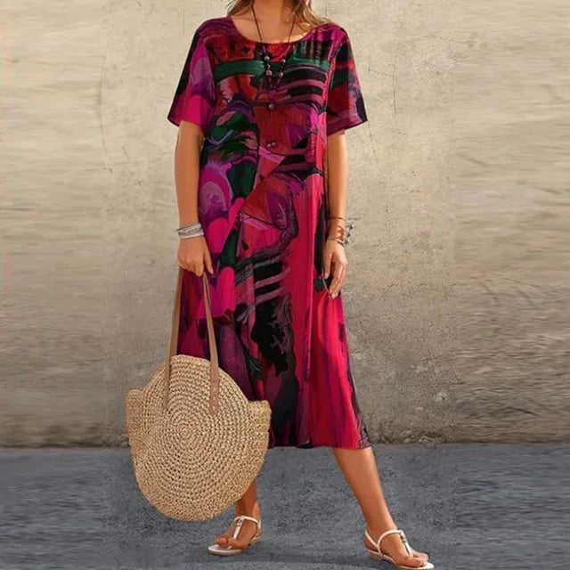 Robe midi ample en tissu fluide, imprimée, manches courtes et col rond, idéale pour un look décontracté en été.