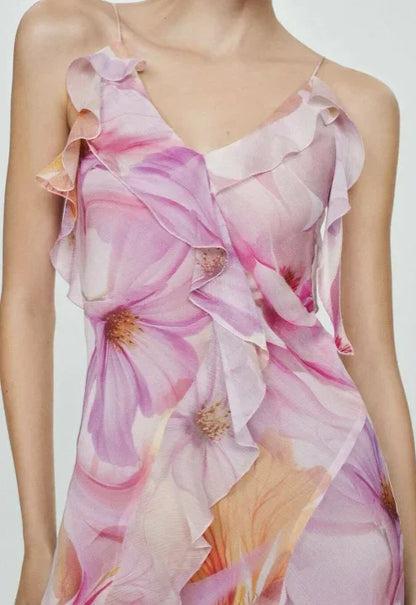 Robe midi asymétrique en tissu léger avec volants et motifs de fleurs roses, idéale pour les soirées d'été.