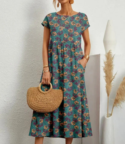 Robe midi en coton bleu avec imprimé floral, dotée de poches pratiques et d'une coupe élégante pour le confort quotidien.
