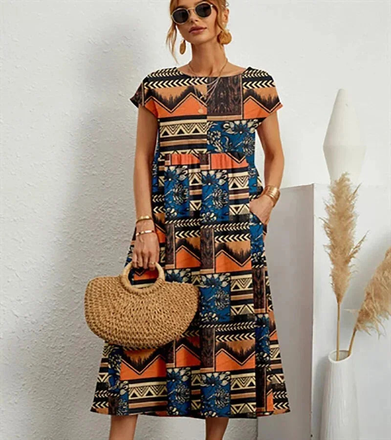 Robe midi orange en coton avec imprimé floral et poches, idéale pour une tenue décontractée au quotidien.