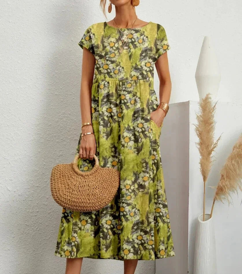 Robe midi en coton vert clair avec imprimé floral et poches, idéale pour une tenue décontractée et estivale.