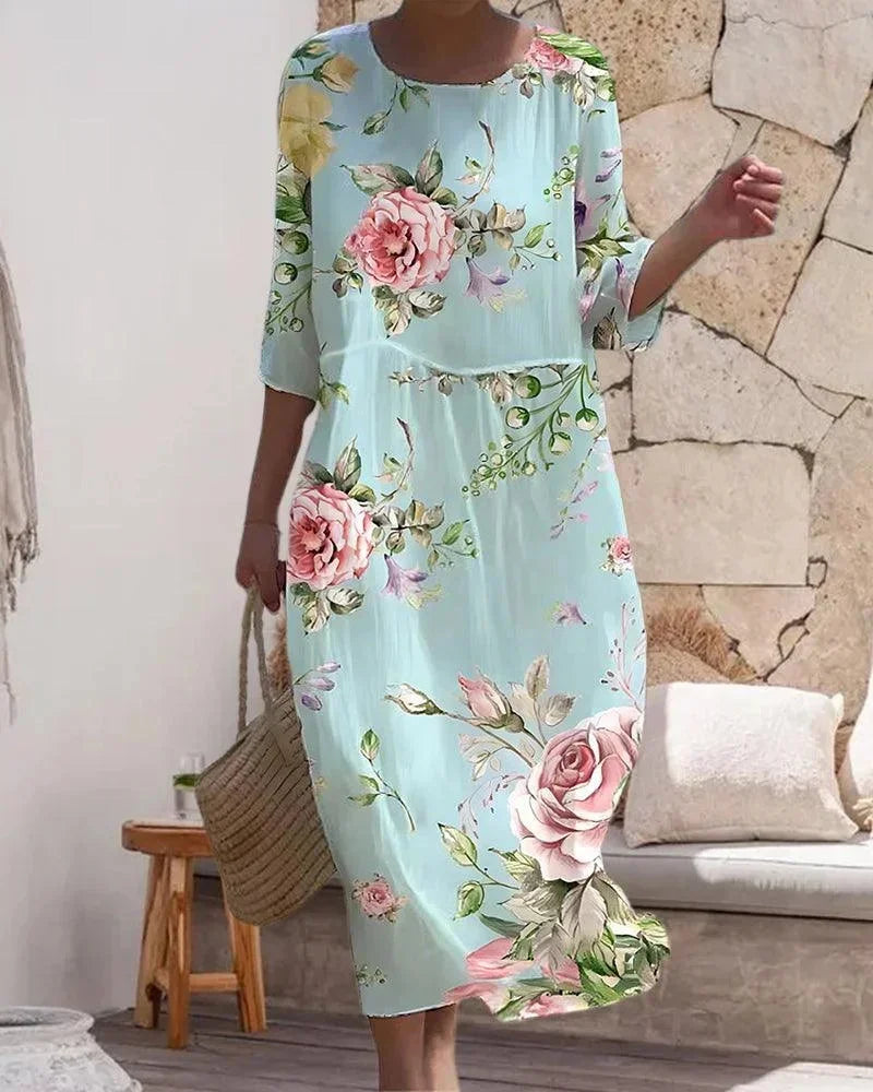Robe midi femme à motifs variés, en coton léger, avec manches mi-longues, idéale pour une journée à la plage.