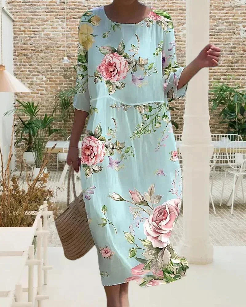 Robe midi femme en coton léger, motifs variés, manches mi-longues, idéale pour des journées décontractées à la plage.