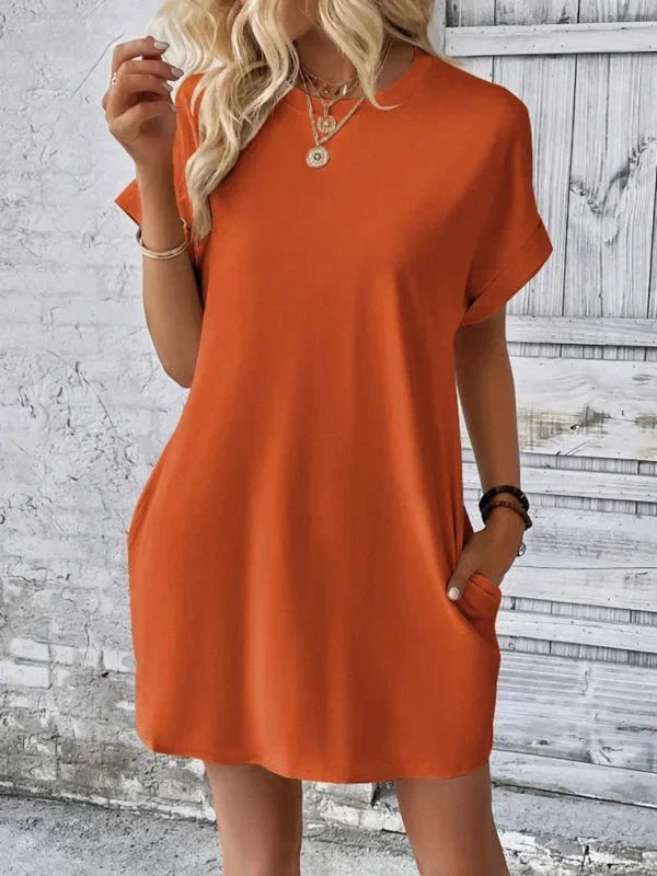 Robe courte à manches courtes en coton léger, dotée de poches pratiques, parfaite pour des journées d'été à la plage.