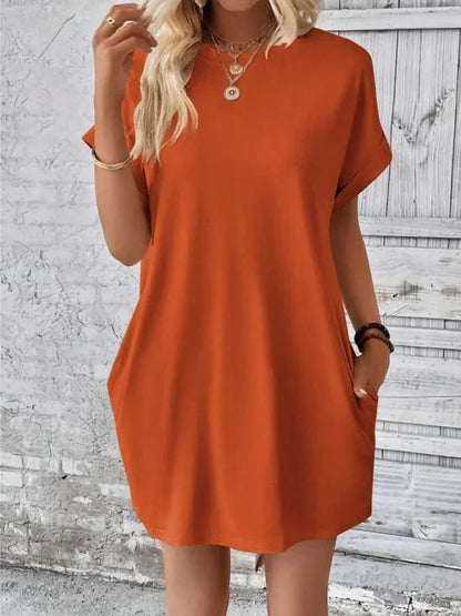 Robe courte à manches courtes en coton léger, avec poches, idéale pour une journée d'été à la plage.