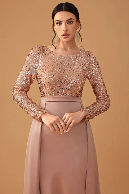 Robe soirée longue en tissu fluide, ornée de sequins scintillants sur la poitrine et jupe élégante pour un look sophistiqué.