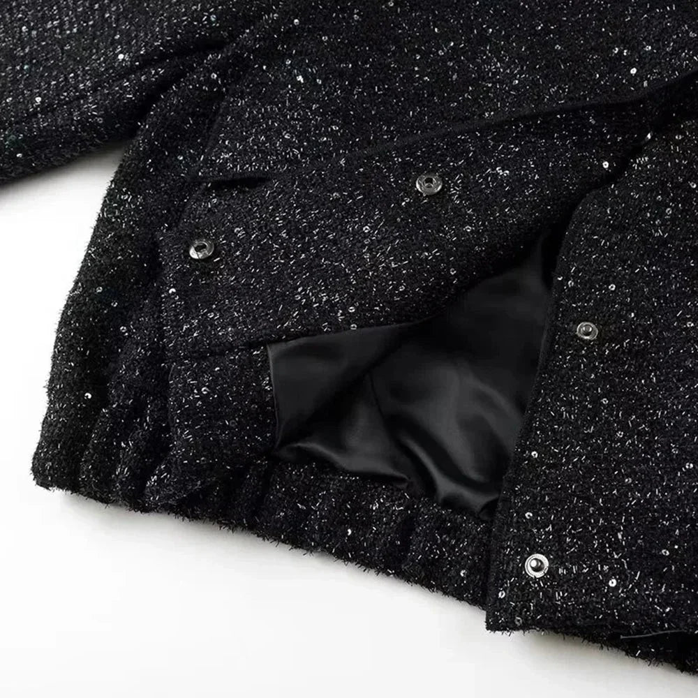 Veste femme à paillettes brillantes, coupe élégante, conçue pour des occasions spéciales.